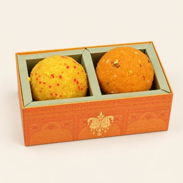 MM Mithaiwala 2 Jumbo Laddu Box displaying yellow and orange laddus in separate compartments of an orange gift box.