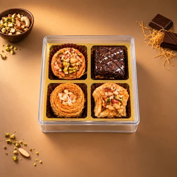 MM Mithaiwala Baklava Box of 4 with assorted nut-topped pastries in a clear box with golden compartments.