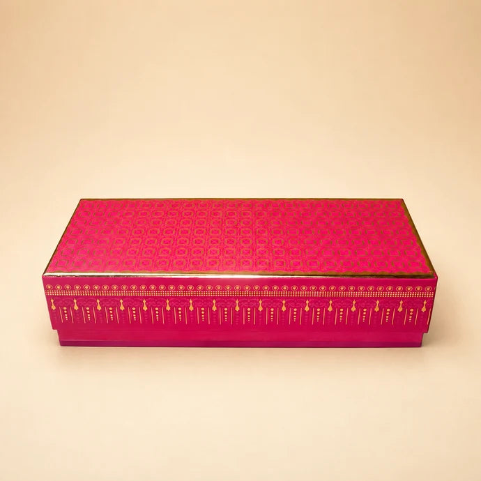 MM Mithaiwala Celebration Trio Jar Box, a closed pink rectangular gift box with golden patterns.