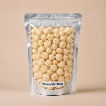 MM Mithaiwala Himalayan Salted Makhana in a silver resealable pouch with a clear front, against a beige background.