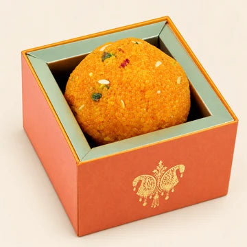 MM Mithaiwala Jumbo Laddu Box with one large orange laddu in an orange gift box with golden detailing.