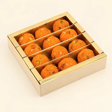 MM Mithaiwala Kesar Dry Fruit Laddu Box with orange laddus garnished with nuts in a gold compartment tray.