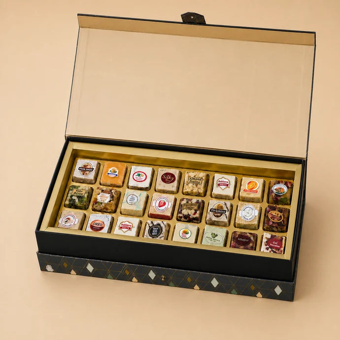 MM Mithaiwala Leather Navy Blue Box, a closed gift box with geometric patterns, a front clasp and a golden brand plaque.