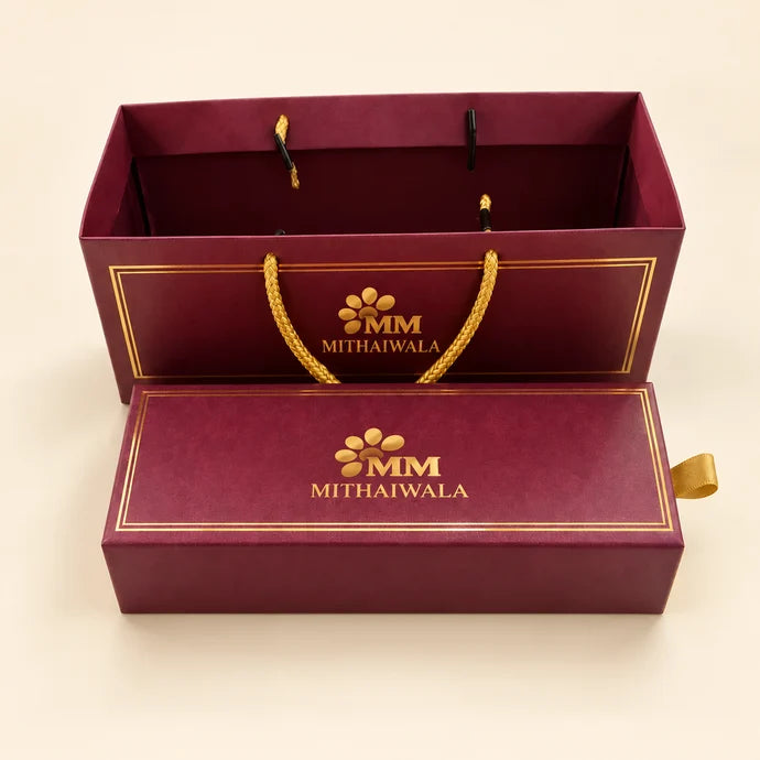 MM Mithaiwala Maroon Cavity Hamper with a matching carry bag, golden borders and branded lettering.