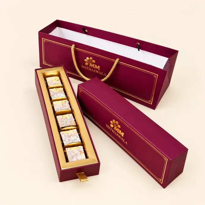 MM Mithaiwala Maroon Cavity Hamper with a matching carry bag, golden borders and branded lettering.