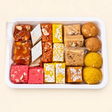 MM Mithaiwala Mix A with assorted colourful mithai and laddus in a white rectangular tray.