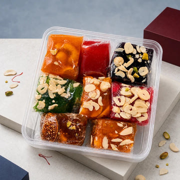 MM Mithaiwala Mix Badami Halwa 500g with Anjeer, Green, Black, Red and Orange varieties, individually wrapped in a clear assortment box.