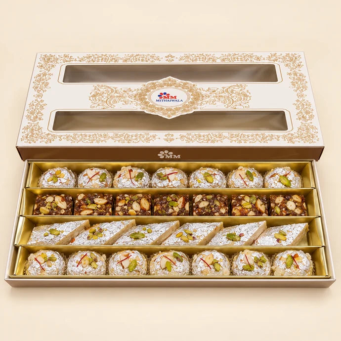 MM Mithaiwala MM Fancy Box 3/4 Kg with ornate golden patterns and two windows displaying assorted mithai.