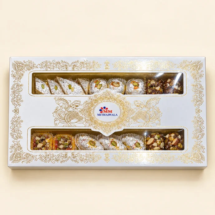 MM Mithaiwala MM Fancy Box 3/4 Kg with ornate golden patterns and two windows displaying assorted mithai.