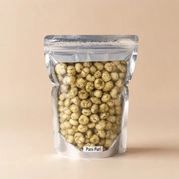 MM Mithaiwala Pani Puri Makhana in a silver resealable pouch with a clear front, against a beige background.