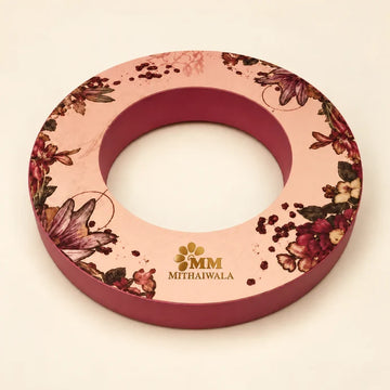 MM Mithaiwala Pink Crown Box, a ring-shaped pink gift box with floral artwork and golden branding.