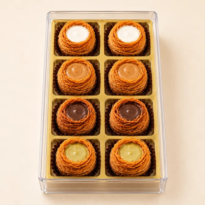 MM Mithaiwala Premium Kunafa Nest Box of 8 with Vanilla, Biscoff, Nutella Hazelnut and Pistachio flavours in a gold compartment tray.
