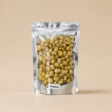 MM Mithaiwala Pudina Makhana in a silver resealable pouch showing green-seasoned makhana through its clear front.