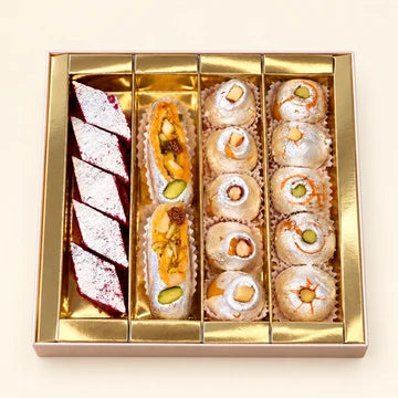 MM Mithaiwala Shanshahi Box with assorted silver-leaf mithai and nut-filled sweets in a gold tray.