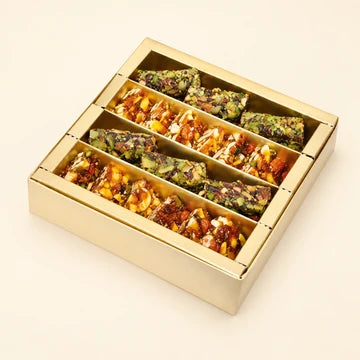 MM Mithaiwala Sugar Free Box with assorted nut-rich sweets arranged in rows in an open gold gift box.