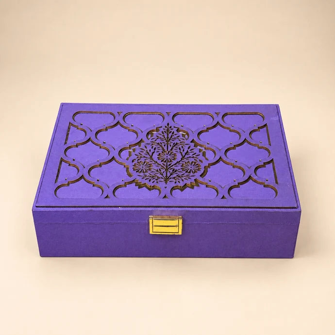 MM Mithaiwala The Imperial Dry Fruit Box, a closed purple gift box with ornate golden patterns and a golden clasp.