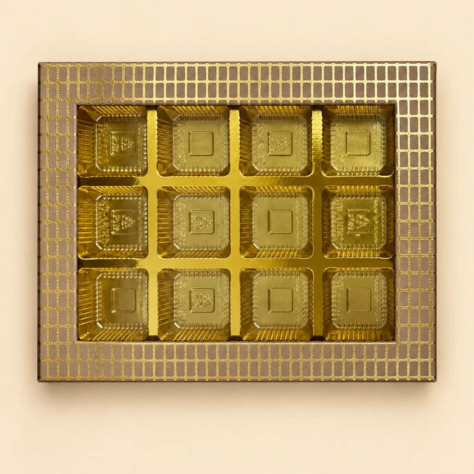 MM Mithaiwala The Pearl Edit 12 Cavity Box with a gold grid-patterned border and twelve gold compartments.